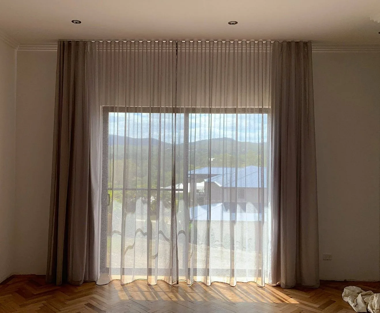 Sheer curtains filtering afternoon light across a Brisbane living room